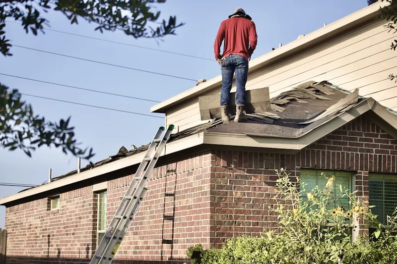 Professional roofer working on a residential roof in Hockessin Park